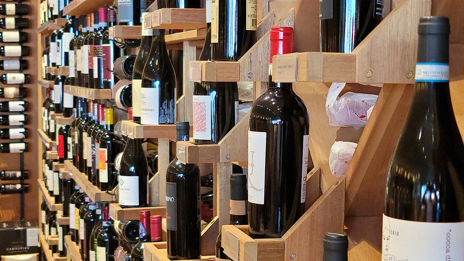 Bottles displayed on the wall at CuVino Trattoria.Pizza.Enoteca